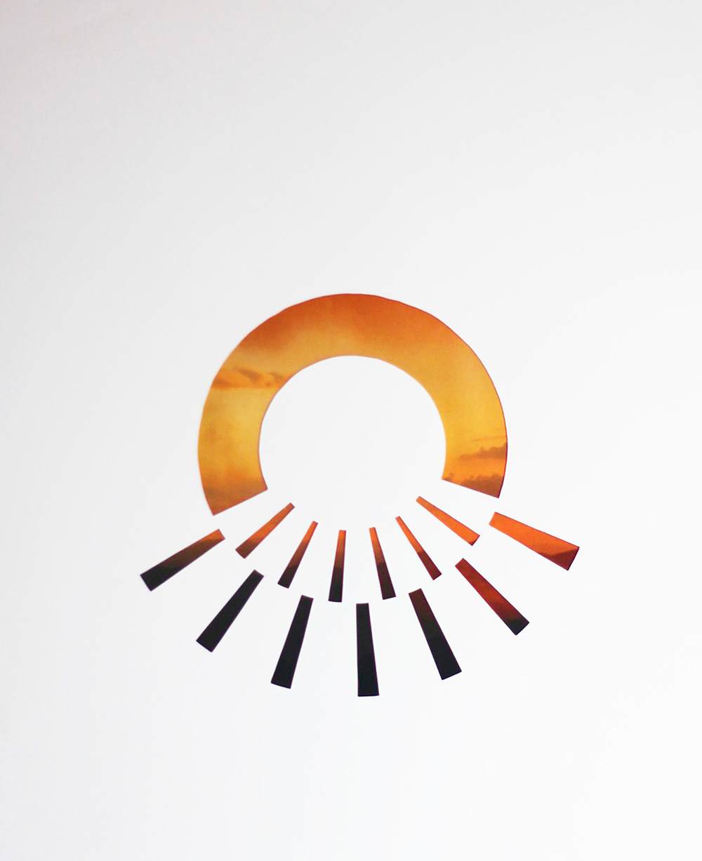 collage cutout with image of orange sun coming throuh